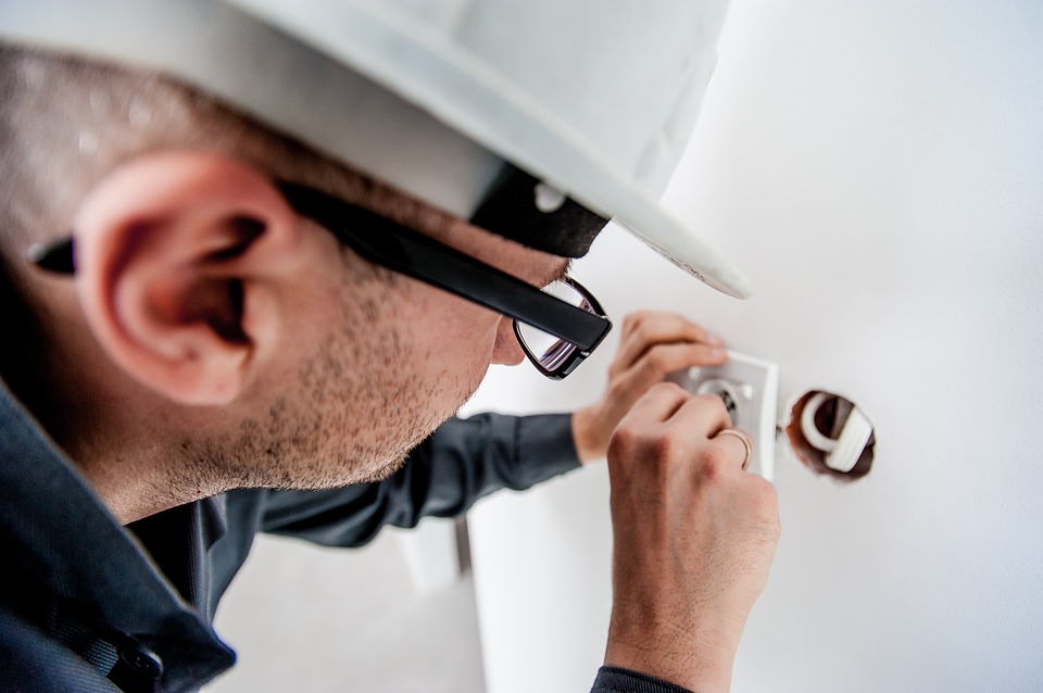 electrician changes electrical socket